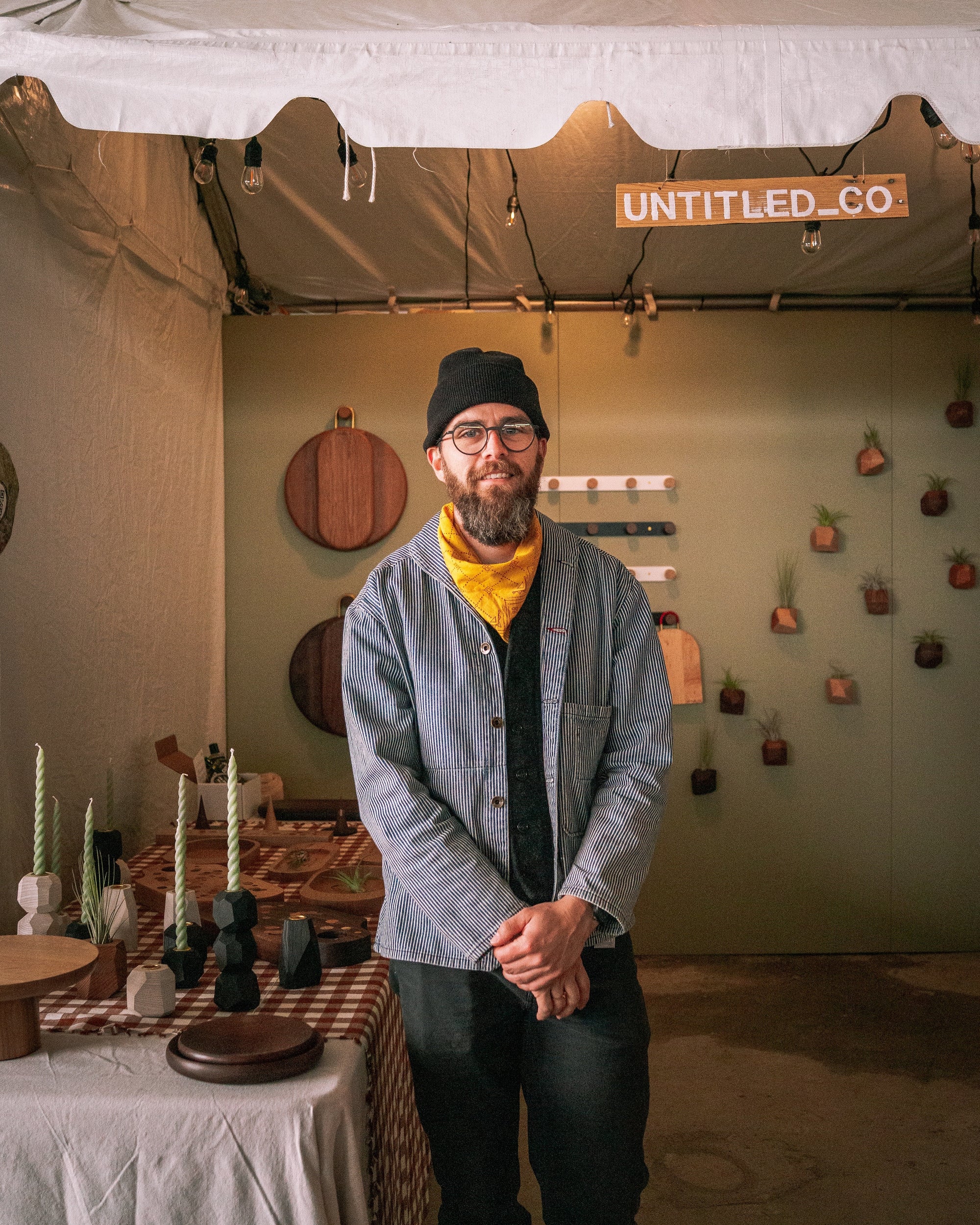 Man standing in front of a display with 'UNTITLED.CO' branding